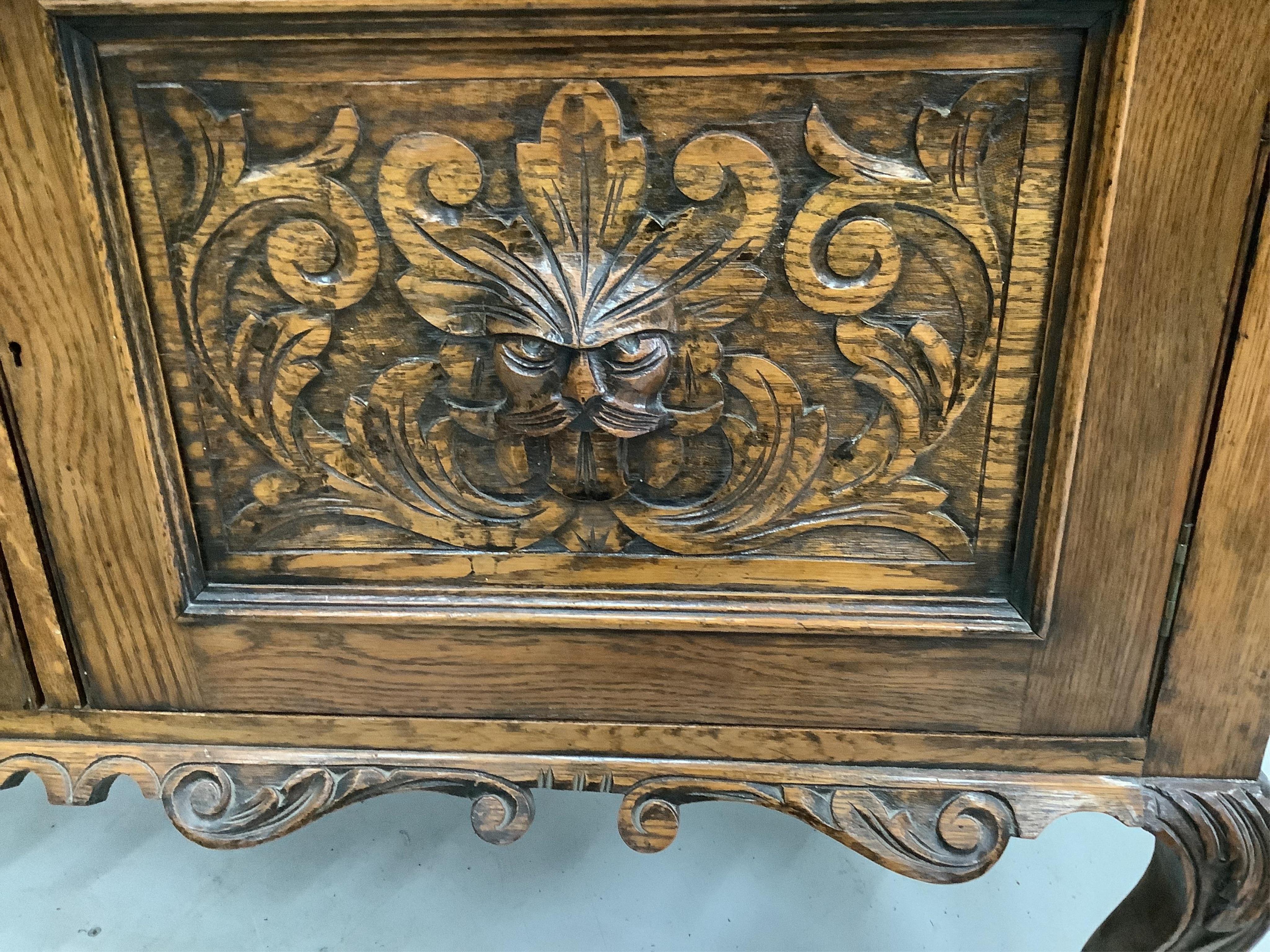 An early 20th century Flemish carved oak bow front dresser, width 138cm, depth 50cm, height 185cm